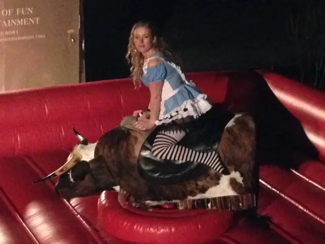 A woman dressed as a maid riding on a mechanical bull