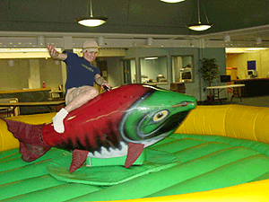 A person riding an inflatable fish
